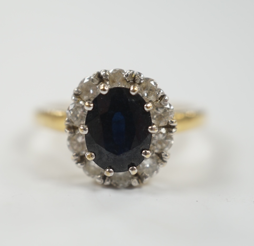 A modern 18ct gold, sapphire and diamond set oval cluster ring, size L, gross weight 3.8 grams.
